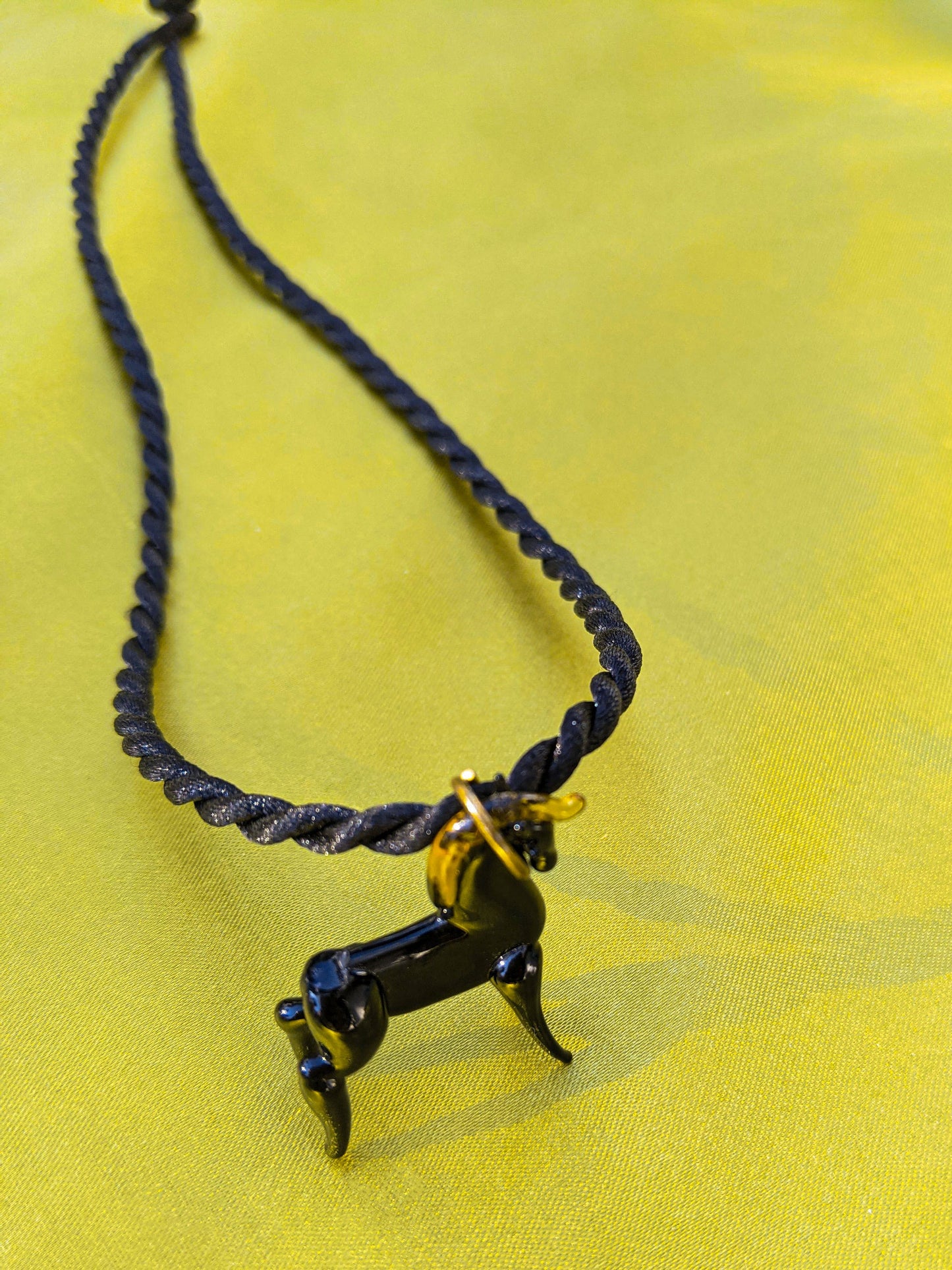 Black rope necklace with a glass horse